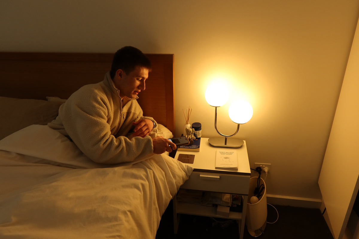 Leaning to the bedside table, the back of the phone touching the Flow